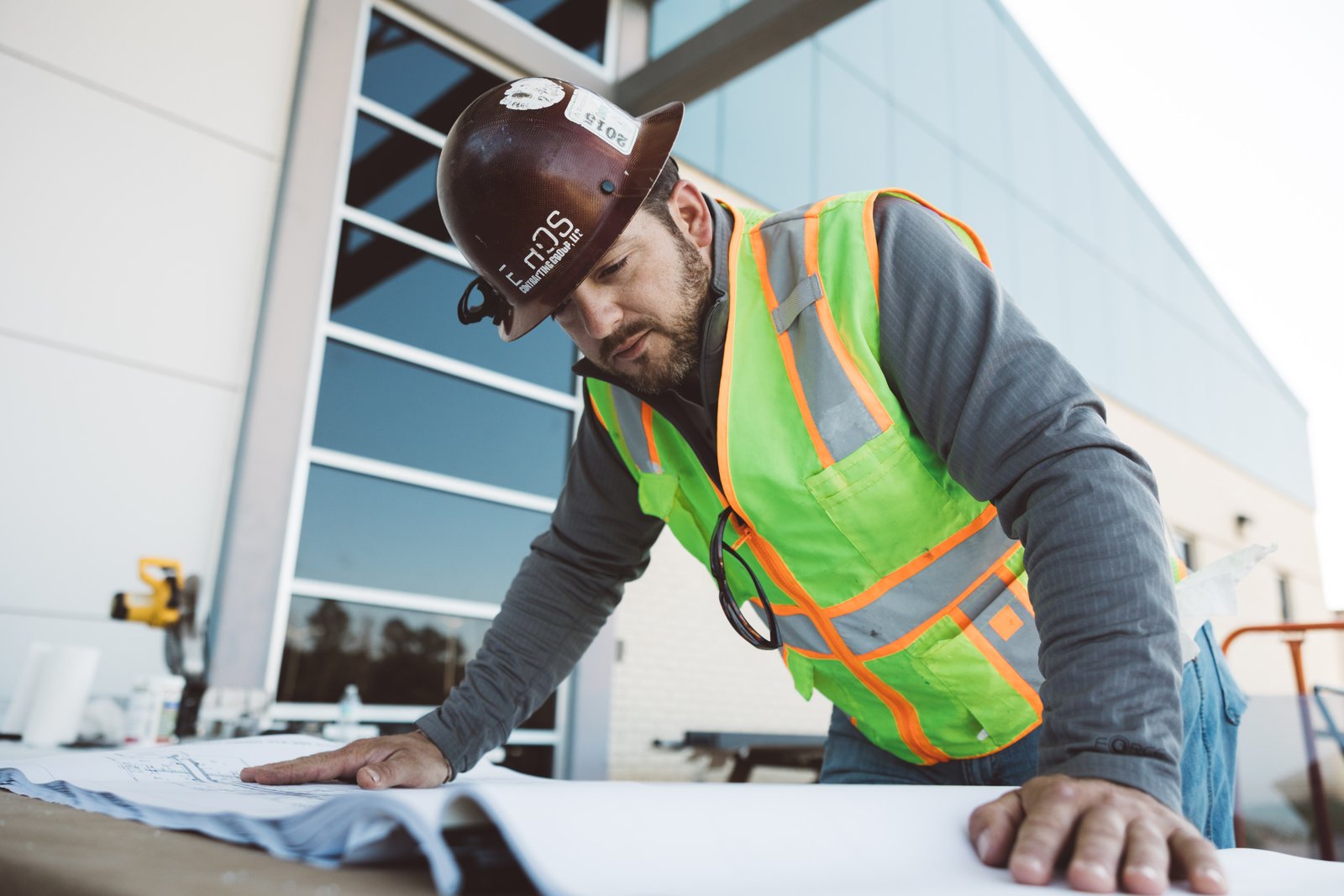 Ethos team member reviewing construction plans on-site