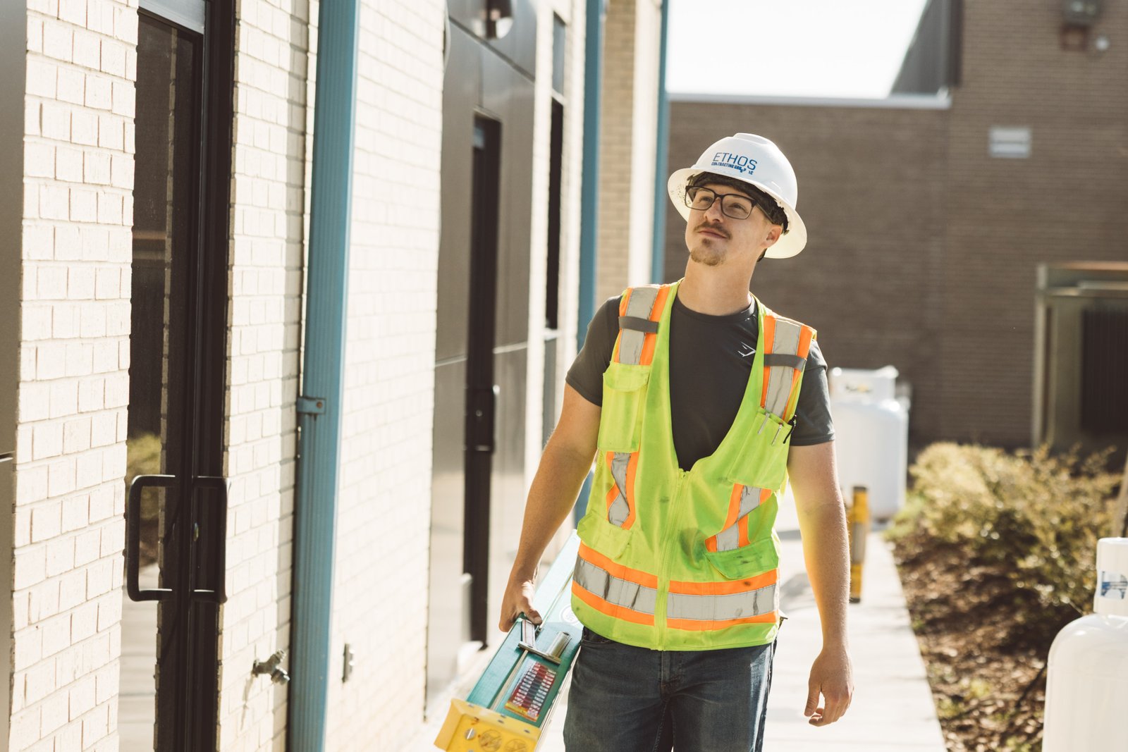 Ethos team member carrying tools on-site