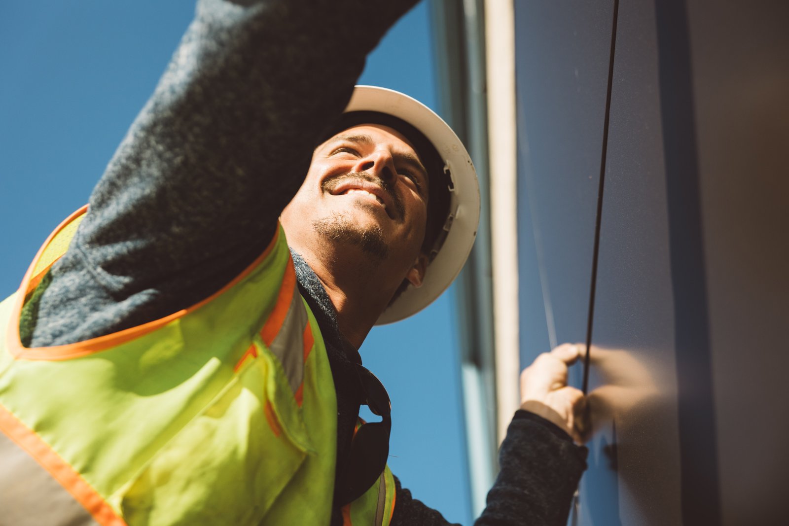 Ethos crew member working at height on building exterior