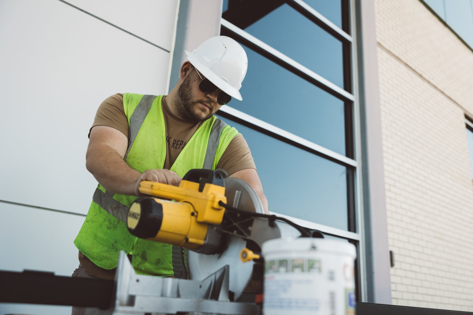 Ethos worker operating a miter saw on-site